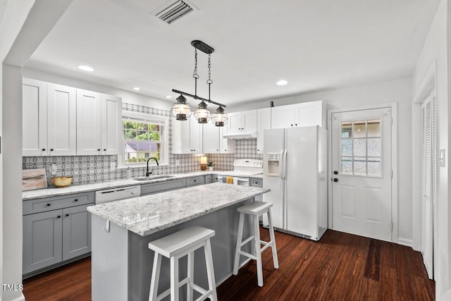 1207 Grant St, Durham, NC 27701 - kitchen with white appliances, a sink, gray cabinetry, decorative backsplash, and recessed lighting