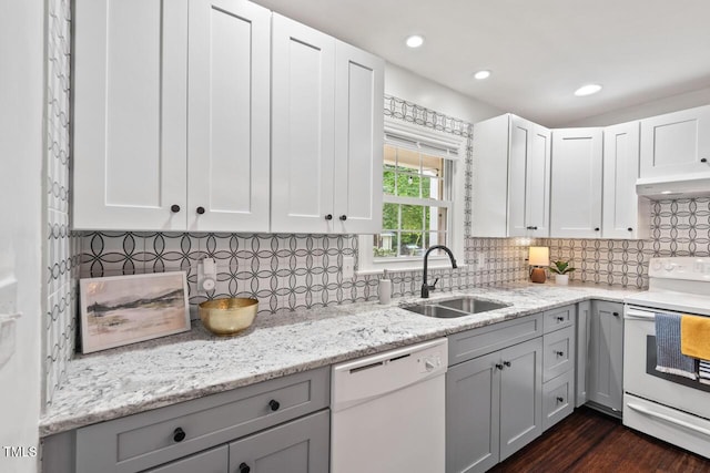1207 Grant St, Durham, NC 27701 - kitchen featuring white appliances, a sink, under cabinet range hood, tasteful backsplash, and light stone countertops