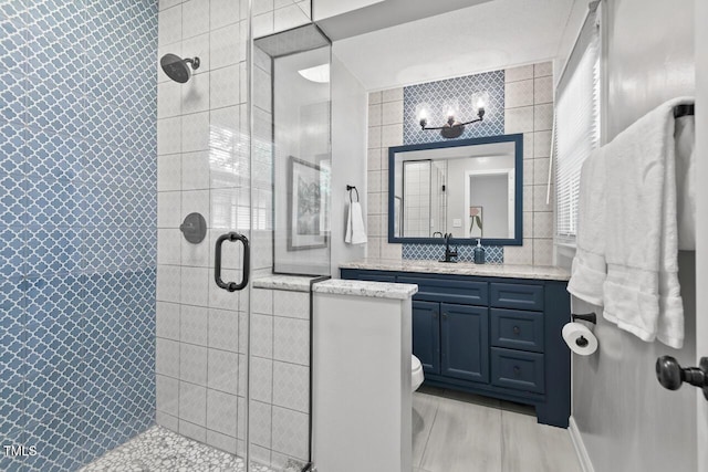 1207 Grant St, Durham, NC 27701 - bathroom featuring a shower stall, vanity, toilet, and tile walls