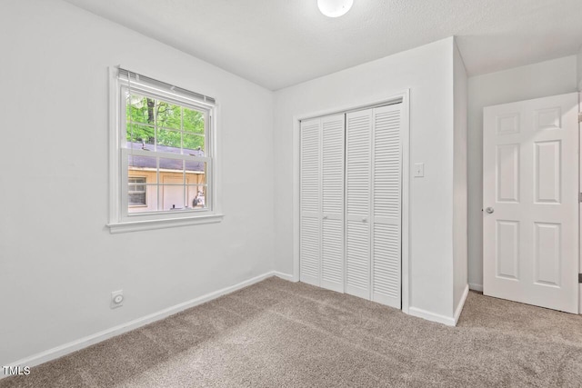 1207 Grant St, Durham, NC 27701 - unfurnished bedroom featuring carpet, a closet, and baseboards