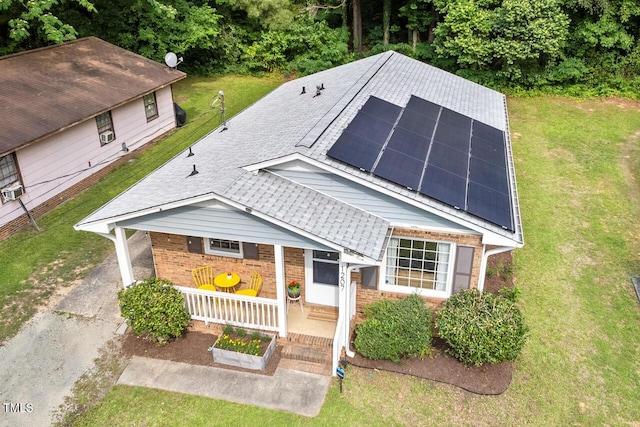 1207 Grant St, Durham, NC 27701 - view of front of property featuring brick siding, a front lawn, solar panels, and a shingled roof