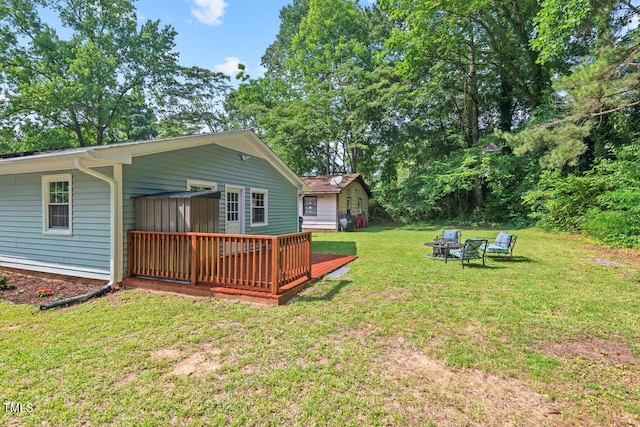 1207 Grant St, Durham, NC 27701 - view of grassy yard featuring a deck and a fire pit