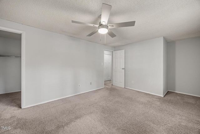 7731 Kingsberry Ct, Raleigh, NC 27615 - unfurnished bedroom featuring carpet flooring, a textured ceiling, a walk in closet, a closet, and a ceiling fan