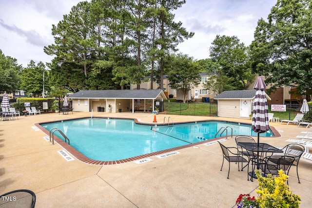 7731 Kingsberry Ct, Raleigh, NC 27615 - community pool featuring a patio area and view of scattered trees