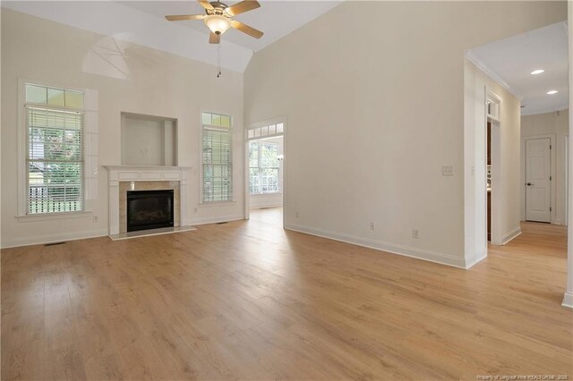 196 Leaning Pine Cir, Spring Lake, NC 28390 - unfurnished living room featuring ceiling fan, baseboards, light wood-type flooring, a fireplace, and high vaulted ceiling