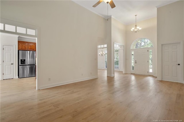 196 Leaning Pine Cir, Spring Lake, NC 28390 - entrance foyer featuring a chandelier, a high ceiling, a ceiling fan, light wood finished floors, and ornamental molding