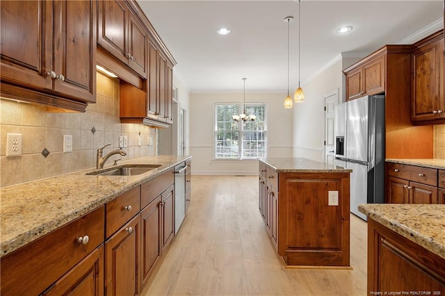 196 Leaning Pine Cir, Spring Lake, NC 28390 - kitchen with appliances with stainless steel finishes, a sink, a chandelier, decorative backsplash, and light stone counters