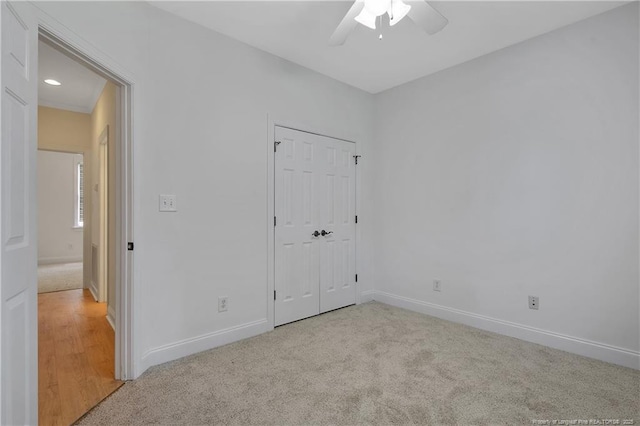 196 Leaning Pine Cir, Spring Lake, NC 28390 - unfurnished bedroom featuring light colored carpet, baseboards, a ceiling fan, and a closet