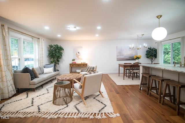 5012 Skidmore St, Raleigh, NC 27609 - living room with wood finished floors, plenty of natural light, a chandelier, and recessed lighting