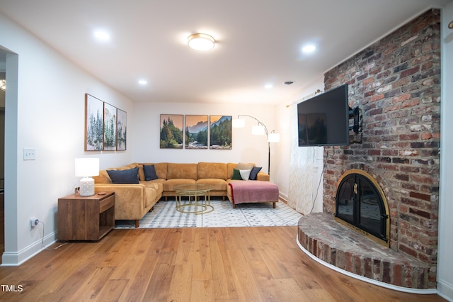 5012 Skidmore St, Raleigh, NC 27609 - living area with hardwood / wood-style flooring, a brick fireplace, and recessed lighting
