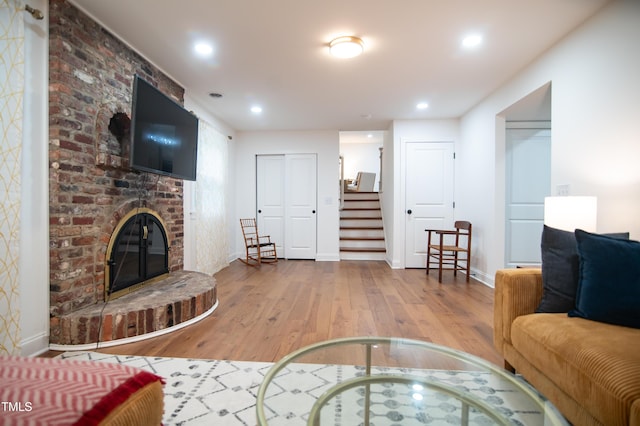 5012 Skidmore St, Raleigh, NC 27609 - living room with wood finished floors, stairway, a fireplace, and recessed lighting