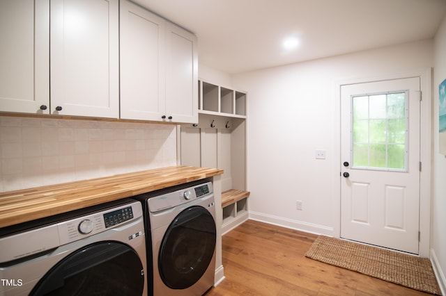 5012 Skidmore St, Raleigh, NC 27609 - laundry room with cabinet space, separate washer and dryer, and light wood finished floors