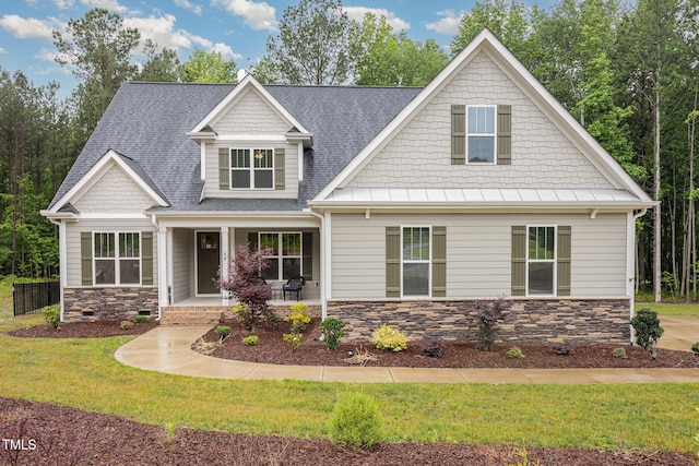 40 Yellowstone Ct, Youngsville, NC 27596 - craftsman house with stone siding, roof with shingles, a front yard, and a porch