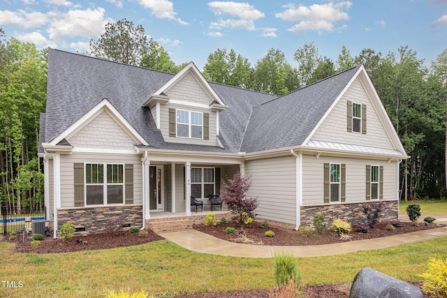 40 Yellowstone Ct, Youngsville, NC 27596 - craftsman inspired home with stone siding, roof with shingles, covered porch, and a front yard