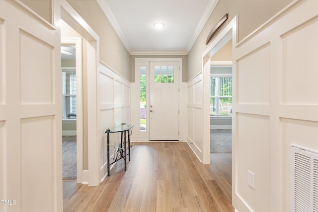 40 Yellowstone Ct, Youngsville, NC 27596 - foyer entrance featuring a decorative wall, light wood finished floors, ornamental molding, and a wainscoted wall