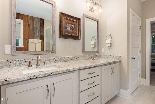 40 Yellowstone Ct, Youngsville, NC 27596 - full bathroom featuring double vanity, baseboards, tile patterned floors, and a shower