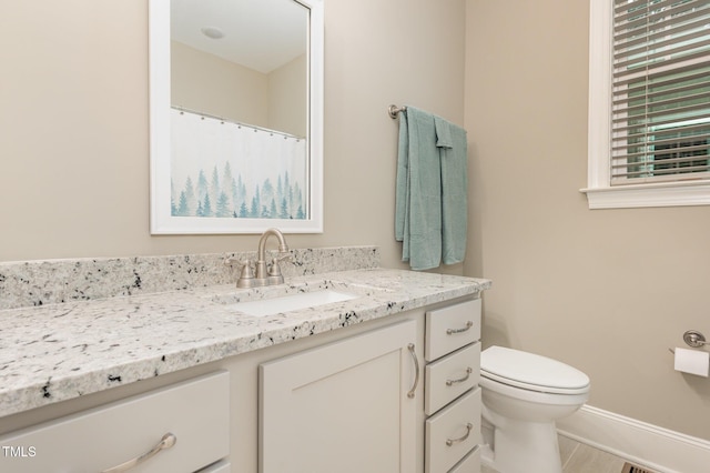 40 Yellowstone Ct, Youngsville, NC 27596 - bathroom with vanity, toilet, baseboards, and wood finished floors