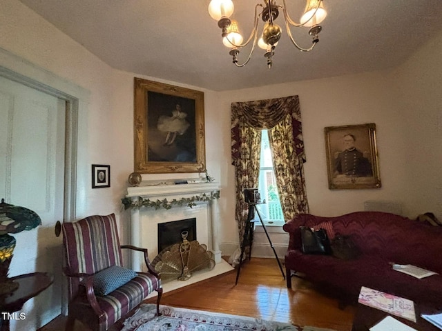 331 N Main St, Warrenton, NC 27589 - living room featuring a fireplace with flush hearth, a chandelier, and wood finished floors