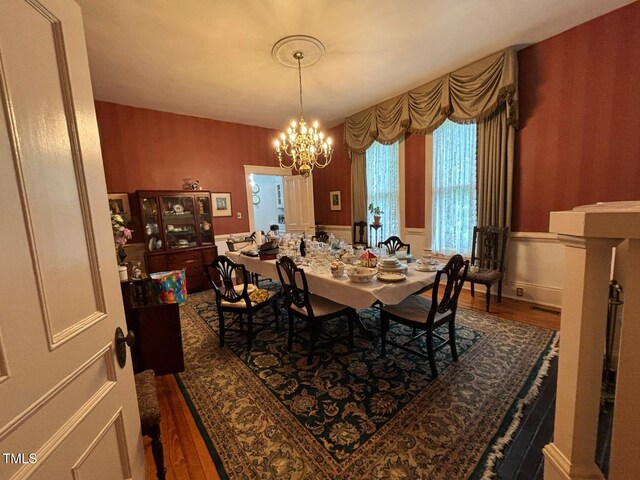 331 N Main St, Warrenton, NC 27589 - dining room featuring wood finished floors, a chandelier, and wainscoting