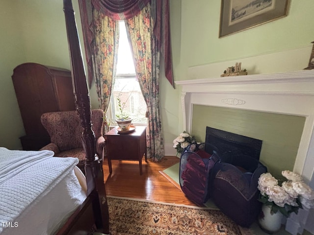331 N Main St, Warrenton, NC 27589 - bedroom featuring wood finished floors and a fireplace