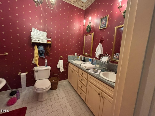 331 N Main St, Warrenton, NC 27589 - bathroom featuring toilet, double vanity, tile patterned floors, and wallpapered walls