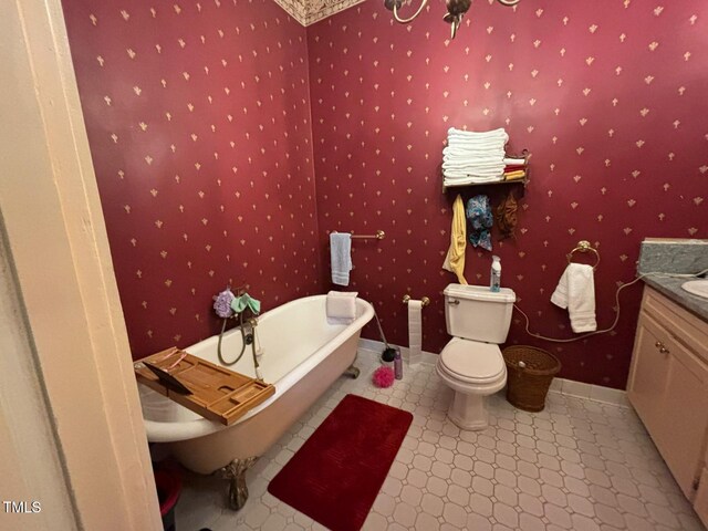 331 N Main St, Warrenton, NC 27589 - bathroom featuring vanity, a freestanding tub, toilet, tile patterned floors, and baseboards