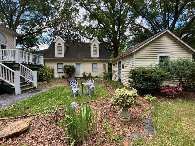 331 N Main St, Warrenton, NC 27589 - view of green lawn featuring a deck and stairs