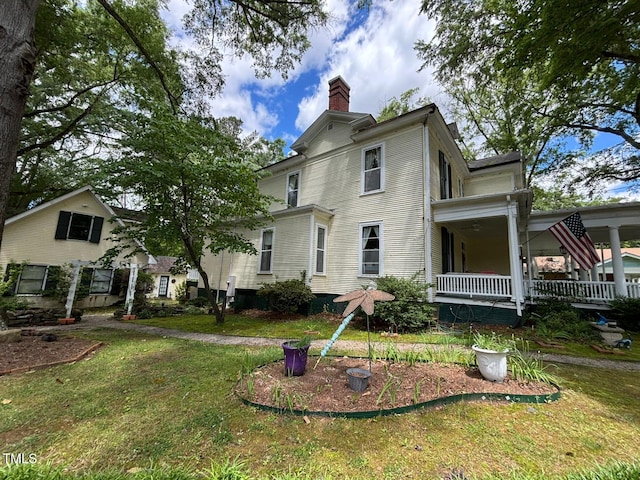 331 N Main St, Warrenton, NC 27589 - view of front facade featuring a chimney, a front yard, and a porch