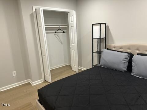 407 Bledsoe Ave, Raleigh, NC 27601 - unfurnished bedroom featuring wood finished floors and a closet