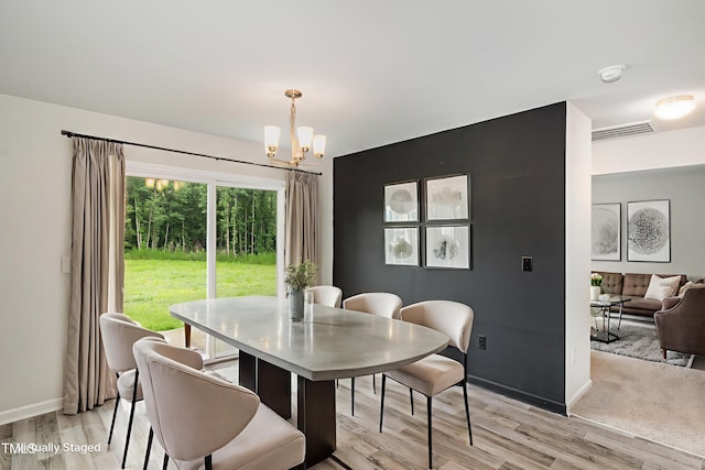 6044 Lowgrass Rd, Stedman, NC 28391 - dining area featuring a chandelier, light wood finished floors, and baseboards