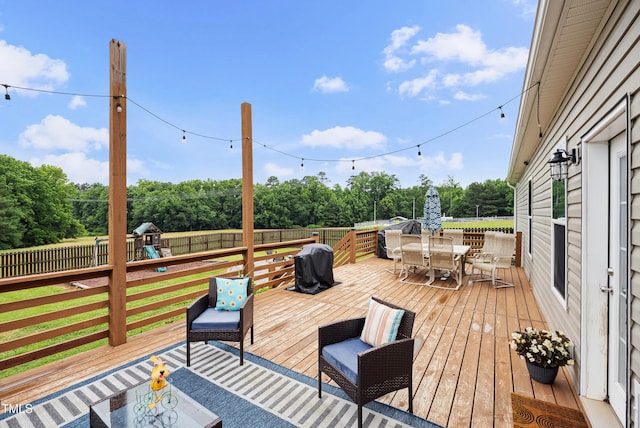 9300 Lake Wheeler Rd, Fuquay Varina, NC 27526 - wooden terrace featuring outdoor dining space, a fenced backyard, a playground, and view of wooded area