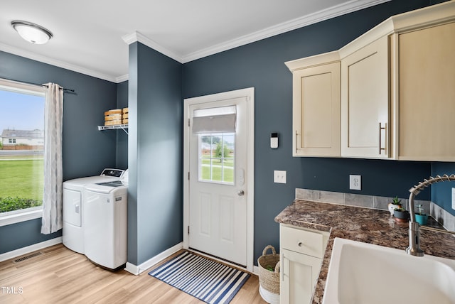 9300 Lake Wheeler Rd, Fuquay Varina, NC 27526 - laundry area featuring light wood-style flooring, baseboards, ornamental molding, and cabinet space