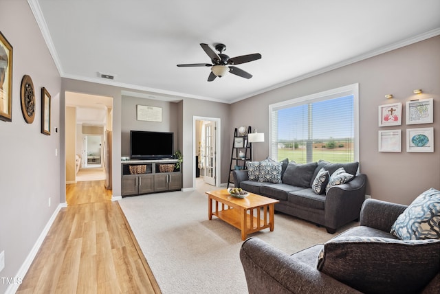 9300 Lake Wheeler Rd, Fuquay Varina, NC 27526 - living area featuring light wood finished floors, crown molding, baseboards, and ceiling fan