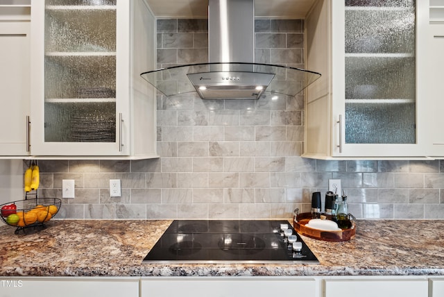 9300 Lake Wheeler Rd, Fuquay Varina, NC 27526 - kitchen featuring wall chimney exhaust hood, black electric stovetop, glass insert cabinets, white cabinetry, and dark stone countertops