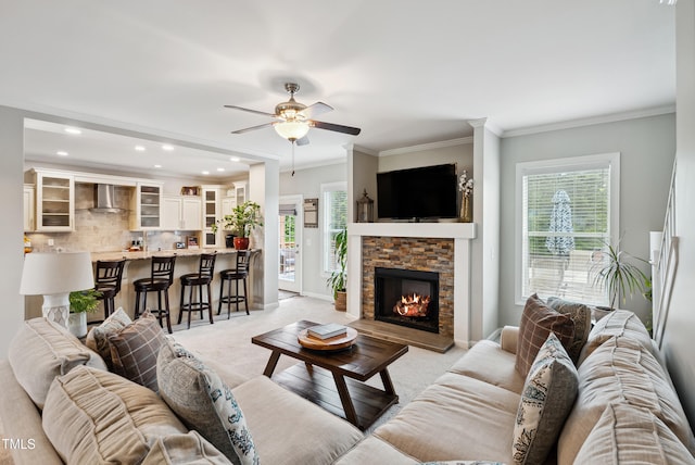 9300 Lake Wheeler Rd, Fuquay Varina, NC 27526 - living area with light carpet, a ceiling fan, ornamental molding, a stone fireplace, and baseboards