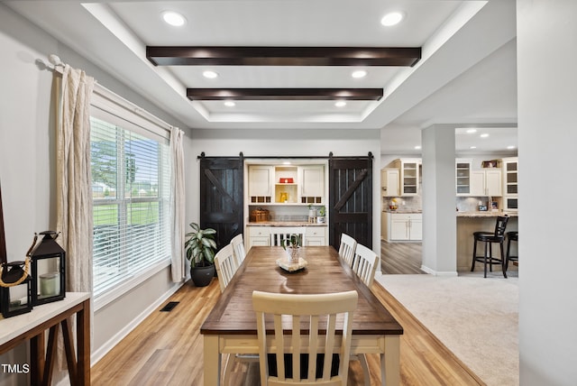 9300 Lake Wheeler Rd, Fuquay Varina, NC 27526 - dining room featuring a barn door, a tray ceiling, light wood-style floors, baseboards, and recessed lighting