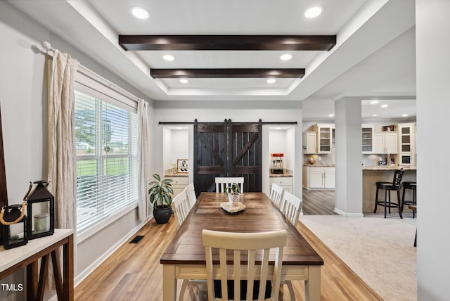 9300 Lake Wheeler Rd, Fuquay Varina, NC 27526 - dining space featuring a barn door, light wood-style flooring, baseboards, a raised ceiling, and recessed lighting