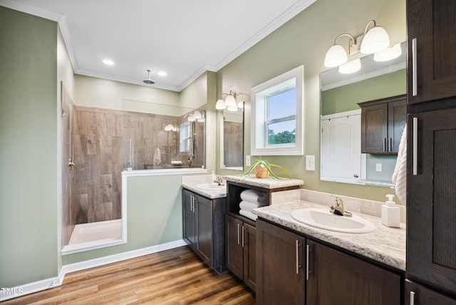 9300 Lake Wheeler Rd, Fuquay Varina, NC 27526 - bathroom with two vanities, a tile shower, ornamental molding, and wood finished floors