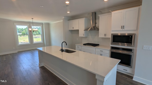 659 Bandon Aly, Cary, NC 27513 - kitchen featuring appliances with stainless steel finishes, a sink, wall chimney range hood, white cabinetry, and a kitchen island with sink