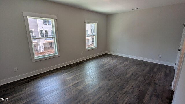 659 Bandon Aly, Cary, NC 27513 - spare room with healthy amount of natural light, dark wood finished floors, and baseboards