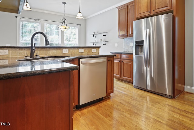 37 Meadow Oaks Cir, Smithfield, NC 27577 - kitchen featuring appliances with stainless steel finishes, a sink, backsplash, light wood-style floors, and brown cabinets