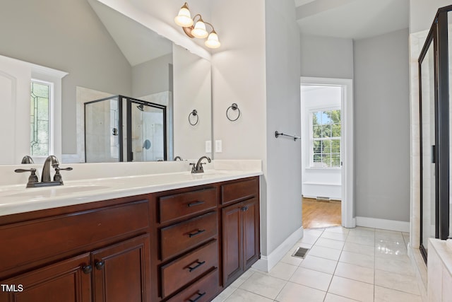 37 Meadow Oaks Cir, Smithfield, NC 27577 - full bathroom with double vanity, a stall shower, tile patterned floors, vaulted ceiling, and baseboards