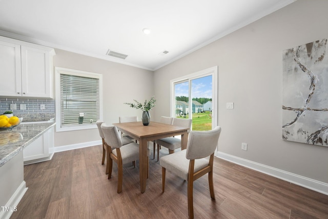 304 Azalea Gaze Dr, Youngsville, NC 27596 - dining space with dark wood-style floors, baseboards, and crown molding