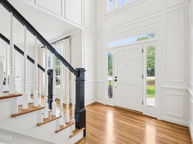 305 Promontory Point Dr, Cary, NC 27513 - foyer featuring a decorative wall, light wood finished floors, plenty of natural light, and stairway
