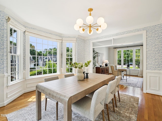 305 Promontory Point Dr, Cary, NC 27513 - dining area with light wood-style flooring, plenty of natural light, a chandelier, wainscoting, and crown molding