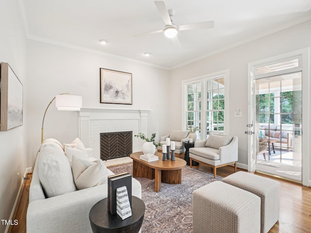 305 Promontory Point Dr, Cary, NC 27513 - living area with wood finished floors, crown molding, a ceiling fan, baseboards, and a fireplace