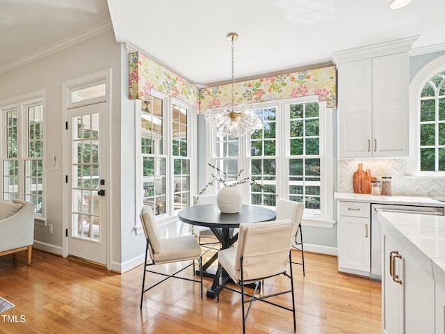 305 Promontory Point Dr, Cary, NC 27513 - dining area with ornamental molding, a chandelier, light wood-style flooring, and baseboards
