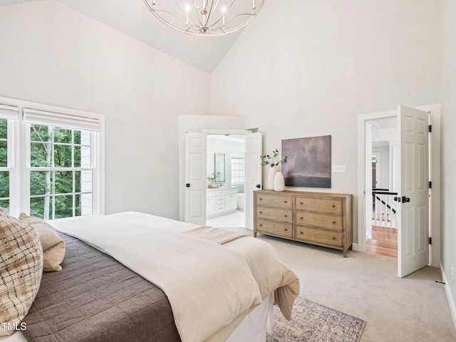 305 Promontory Point Dr, Cary, NC 27513 - bedroom with high vaulted ceiling, a chandelier, light colored carpet, and ensuite bath