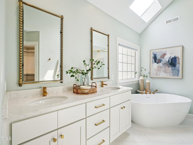 305 Promontory Point Dr, Cary, NC 27513 - bathroom featuring double vanity, a freestanding bath, lofted ceiling, a skylight, and tile patterned flooring