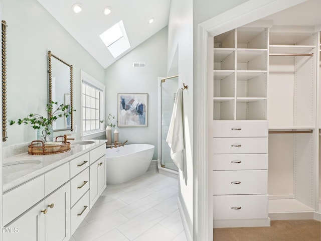 305 Promontory Point Dr, Cary, NC 27513 - full bathroom with a skylight, a walk in closet, a freestanding tub, double vanity, and a shower stall